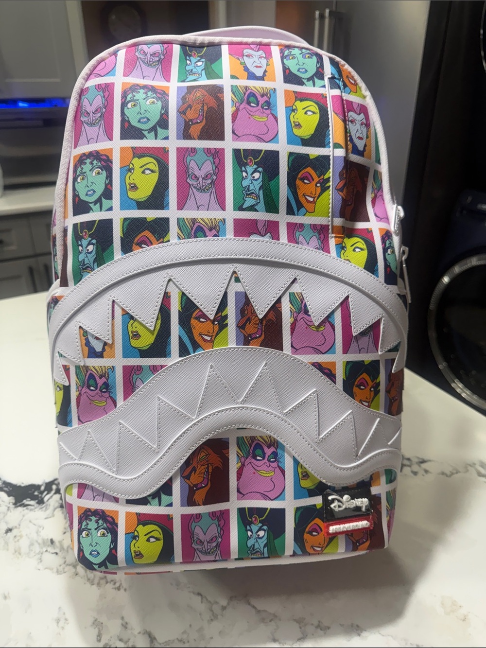 Sprayground Disney Backpack with Colorful Villain Portraits and White Trim